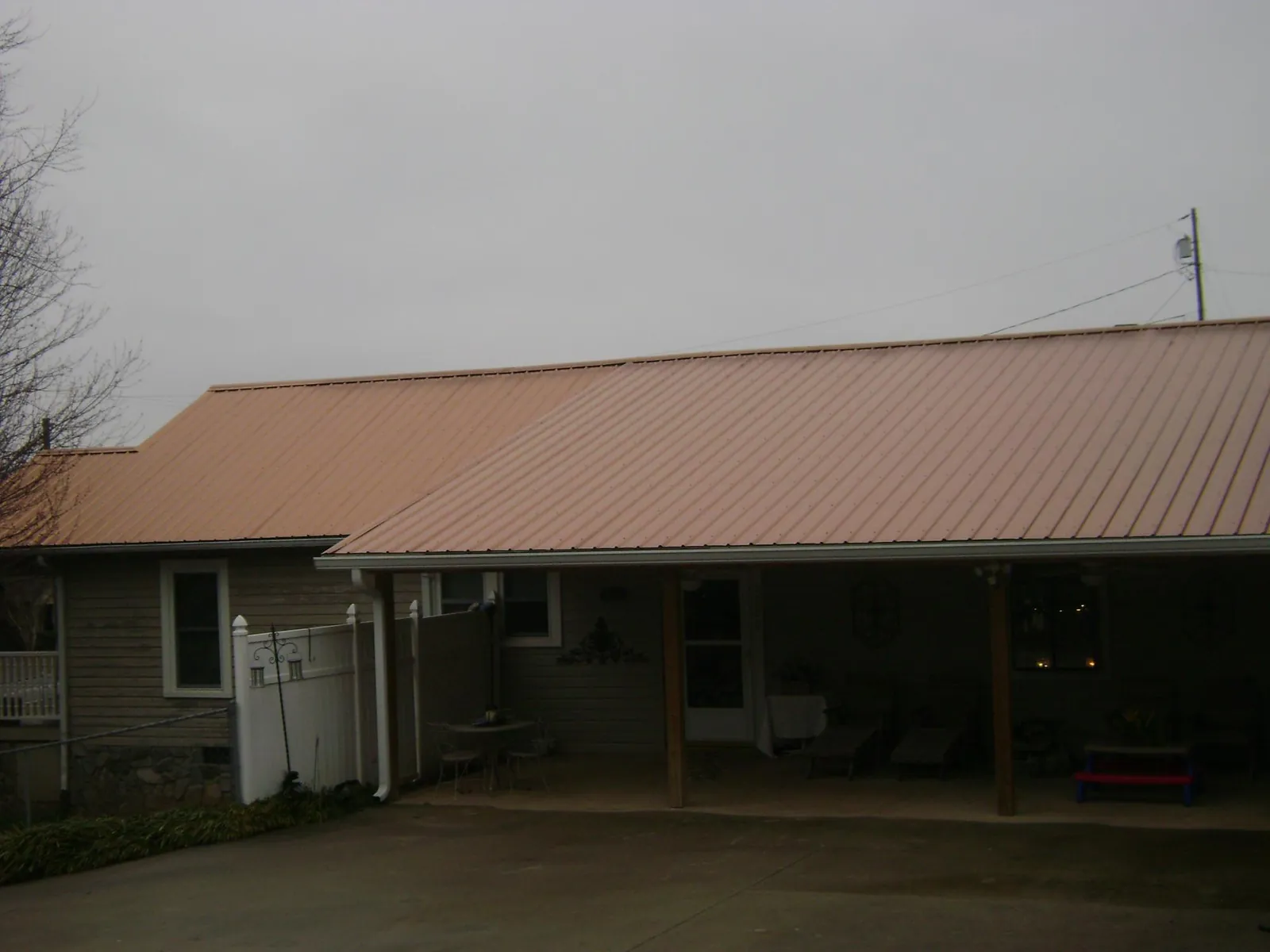 Copper toned metal roof over a wide covered patio in Topeka